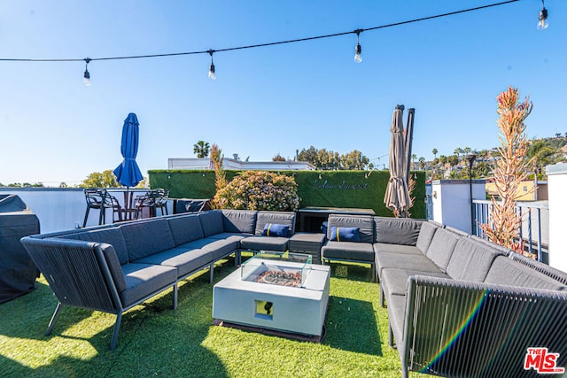 view of patio featuring an outdoor living space with a fire pit