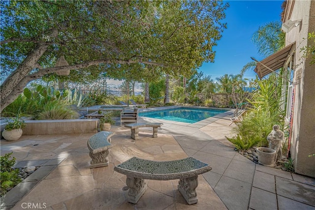 view of swimming pool with a patio area