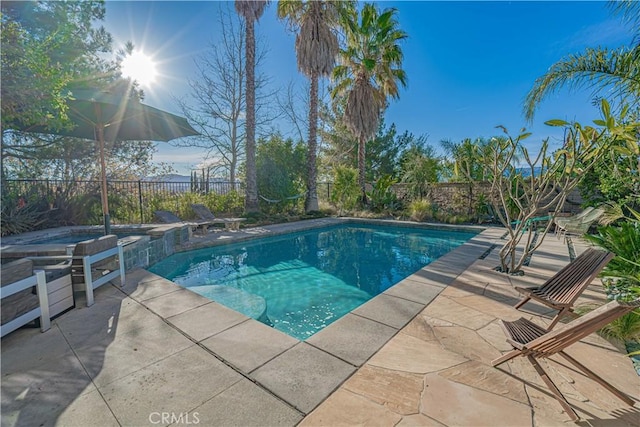 view of swimming pool featuring an in ground hot tub and a patio