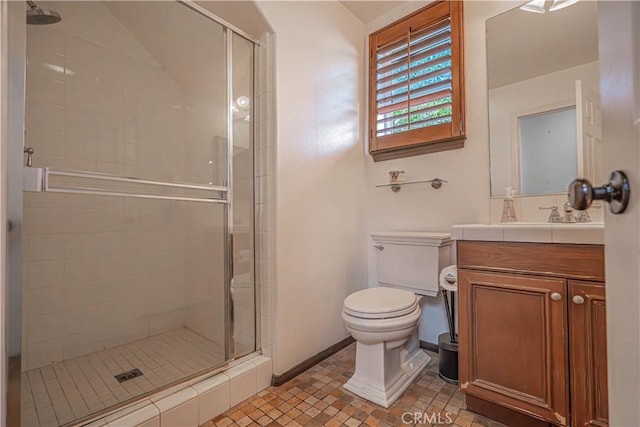 bathroom featuring an enclosed shower, vanity, and toilet