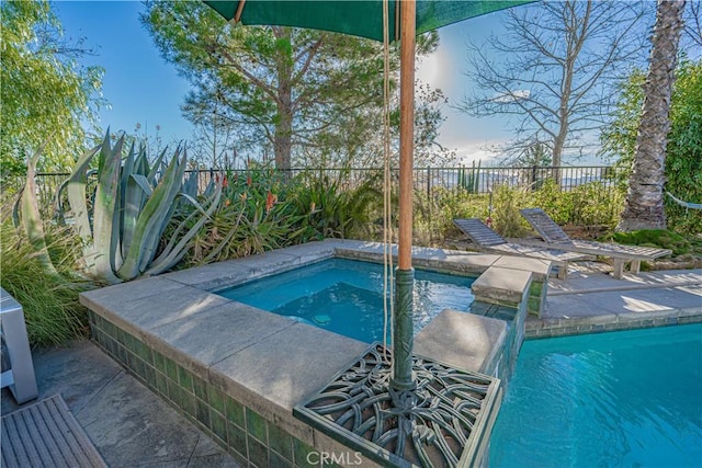 view of swimming pool featuring an in ground hot tub