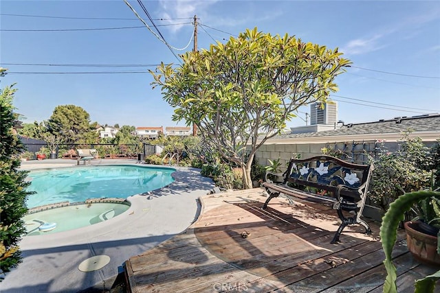 view of pool with a deck and an in ground hot tub