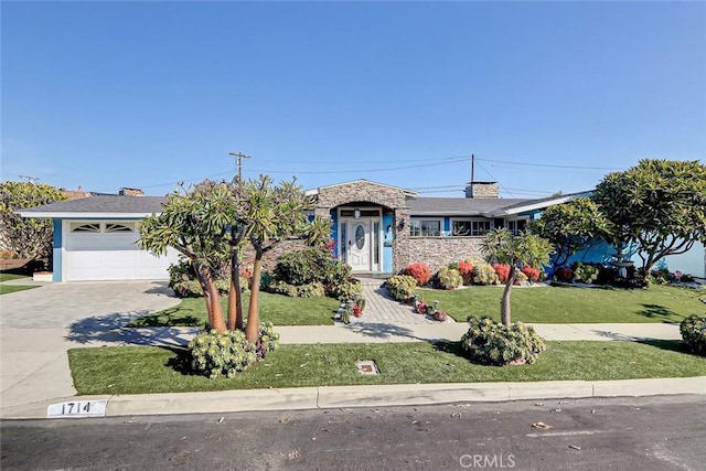 view of front of home with a garage and a front lawn