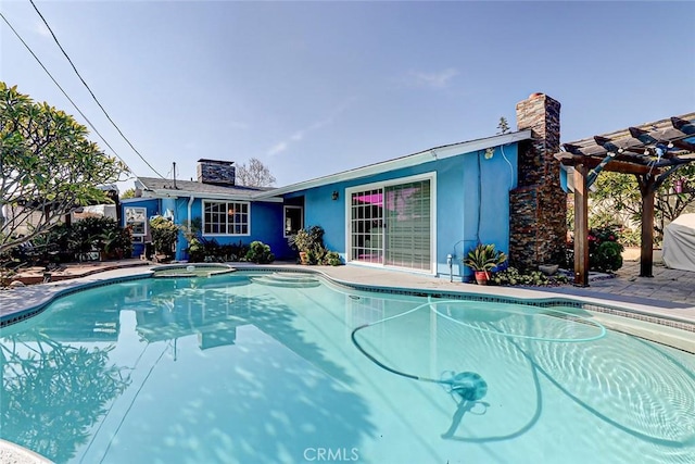 view of pool with an in ground hot tub, a patio, and a pergola