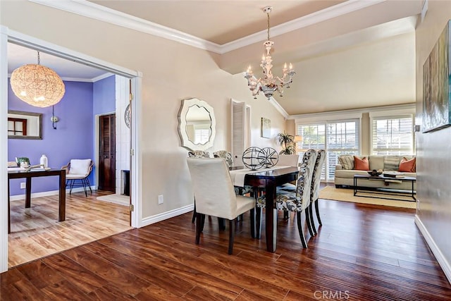 dining space featuring hardwood / wood-style flooring, crown molding, and a notable chandelier