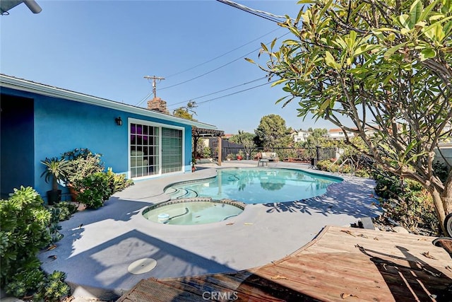 view of swimming pool with an in ground hot tub