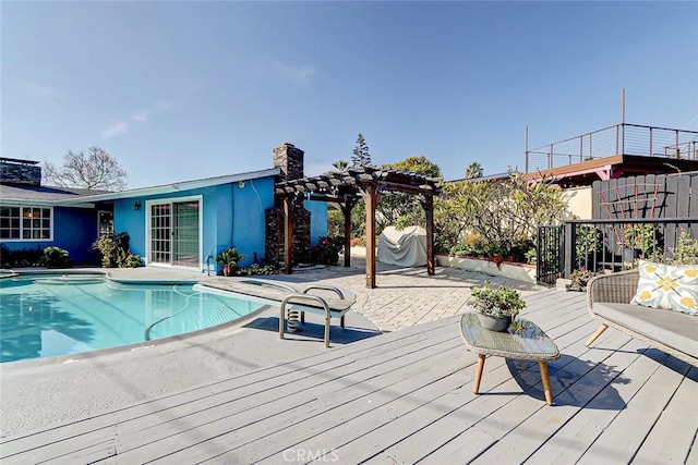 view of pool featuring a wooden deck, a patio area, and a pergola