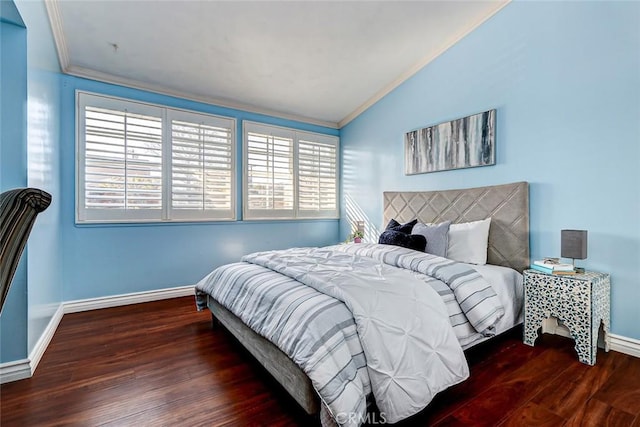 bedroom with dark wood-type flooring, ornamental molding, and vaulted ceiling