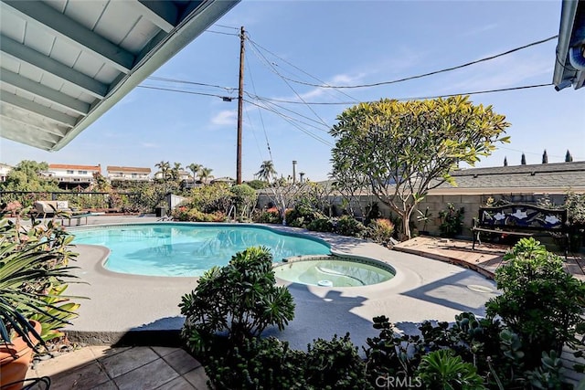 view of swimming pool with a patio area and an in ground hot tub