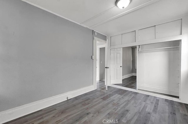 unfurnished bedroom with hardwood / wood-style floors