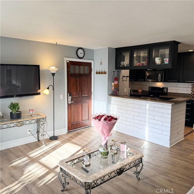 living room with sink and light hardwood / wood-style floors