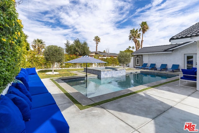 view of swimming pool featuring an in ground hot tub and a patio