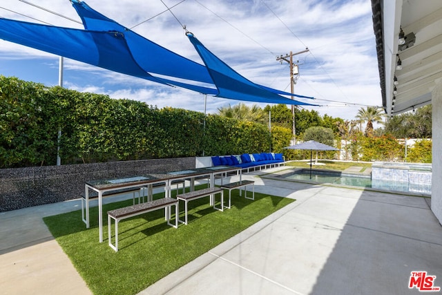 view of community with a patio area, a swimming pool, and a lawn