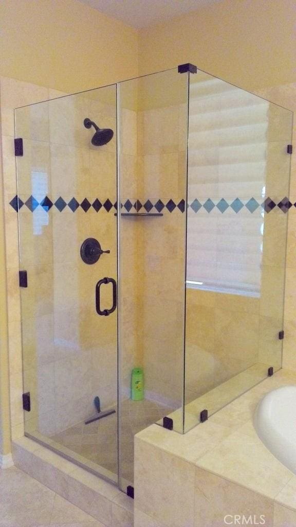 bathroom featuring separate shower and tub and tile patterned flooring