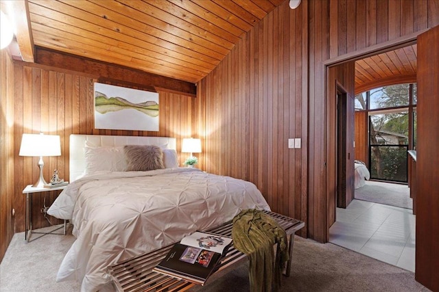 bedroom featuring light carpet, access to exterior, wood ceiling, and wooden walls