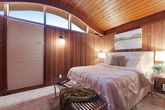 carpeted bedroom with wooden walls, vaulted ceiling, and wooden ceiling