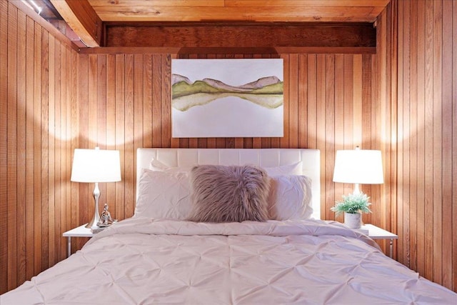 bedroom featuring wood walls