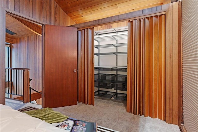 bedroom featuring lofted ceiling, carpet flooring, and wood ceiling