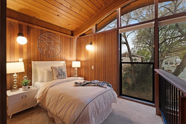 bedroom with wood walls, multiple windows, and wooden ceiling