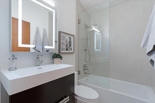 full bathroom with vanity, toilet, and tiled shower / bath