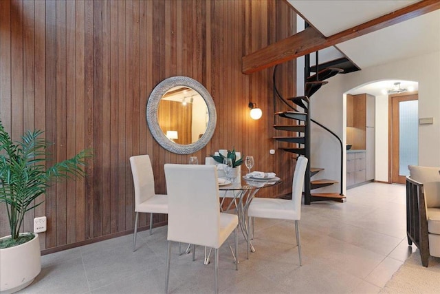 dining space with wood walls