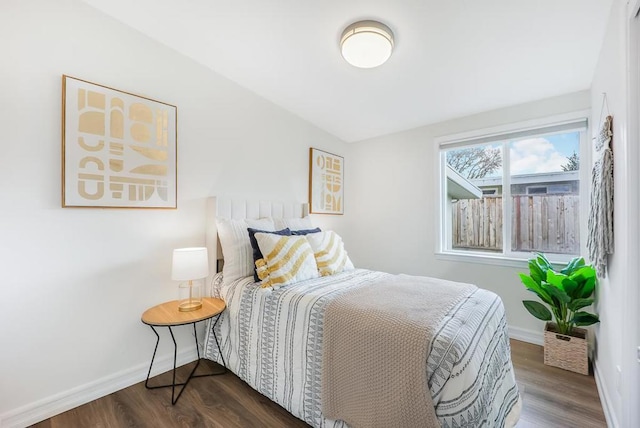 bedroom with dark hardwood / wood-style floors