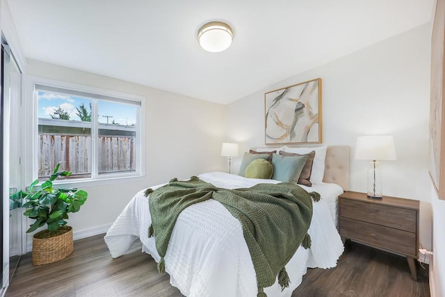 bedroom with dark hardwood / wood-style floors