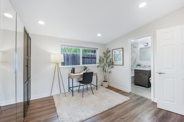 home office with dark wood-type flooring and sink