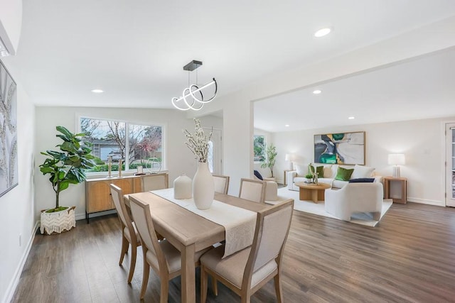 dining space with a notable chandelier and dark wood-type flooring