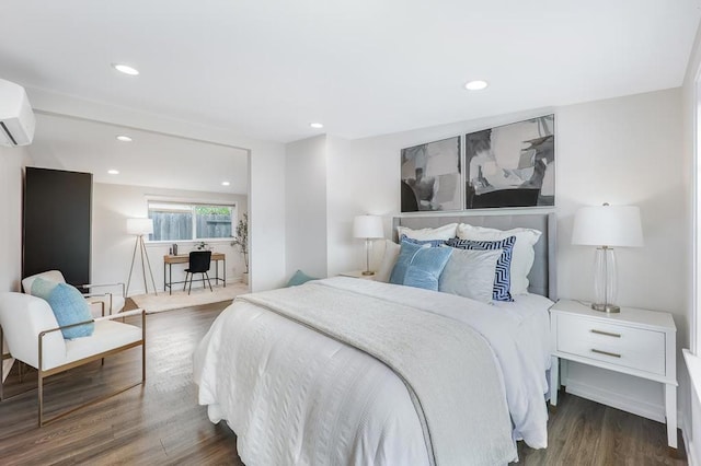 bedroom featuring an AC wall unit and dark wood-type flooring