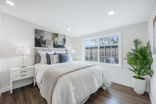 bedroom with dark hardwood / wood-style flooring