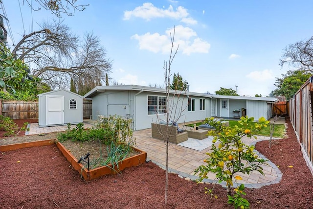 rear view of property with a storage shed, outdoor lounge area, and a patio