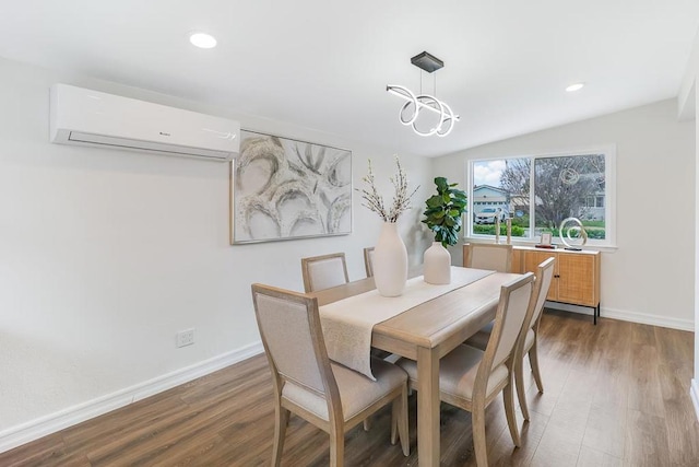 dining area featuring a wall mounted air conditioner, dark hardwood / wood-style flooring, and a chandelier