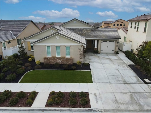 view of front of house featuring a garage and a front lawn