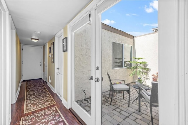 hall featuring dark wood-type flooring and french doors