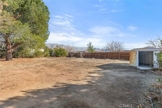 view of yard with a mountain view and a shed