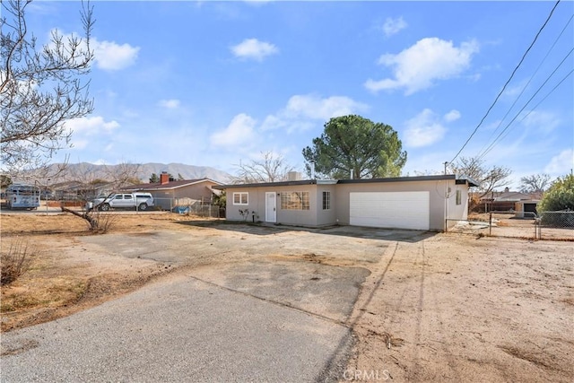 single story home with a mountain view and a garage