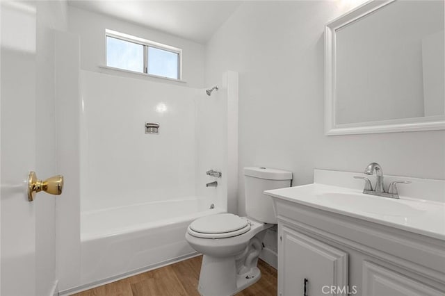 full bathroom with shower / bathing tub combination, hardwood / wood-style floors, vanity, and toilet