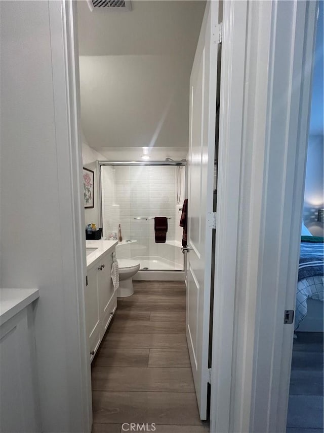 bathroom with vanity, an enclosed shower, wood-type flooring, and toilet