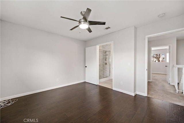 unfurnished bedroom with dark wood-type flooring, ensuite bath, and ceiling fan