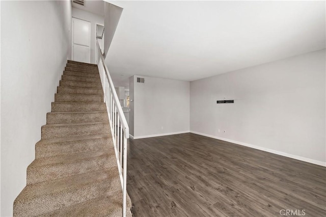 staircase with hardwood / wood-style flooring