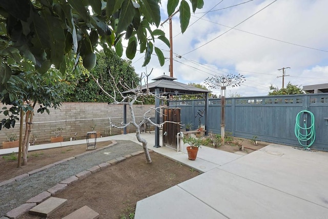 exterior space with a fenced backyard and a gazebo