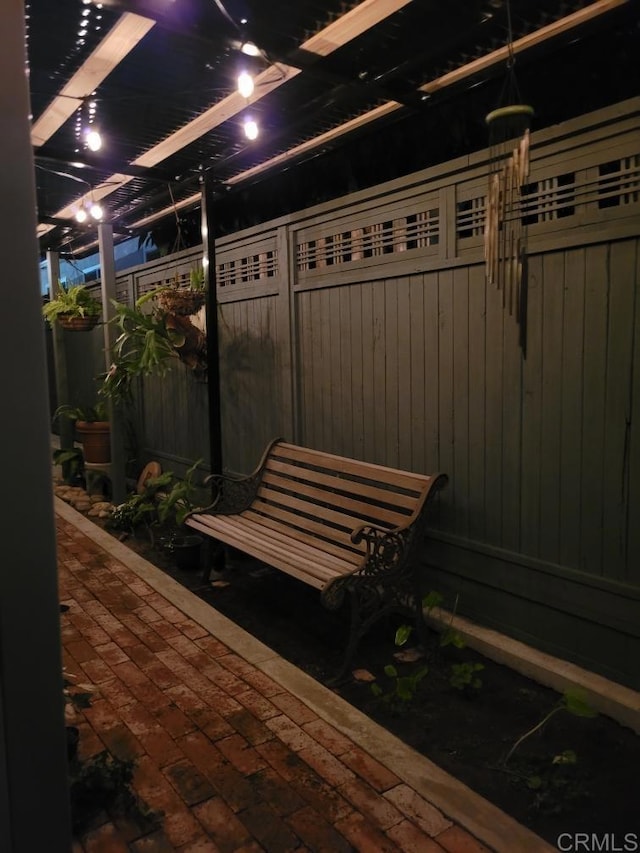 patio at twilight featuring fence