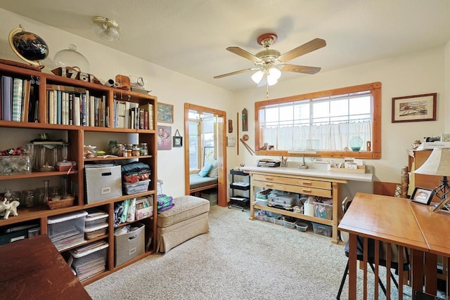 office area with ceiling fan and carpet