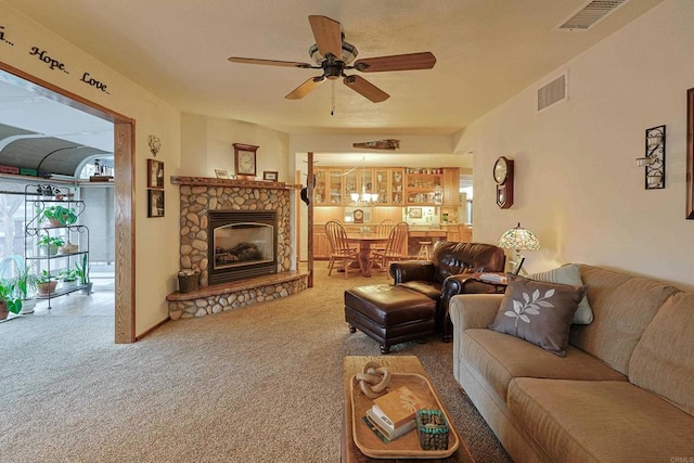 living room with ceiling fan, carpet floors, and visible vents