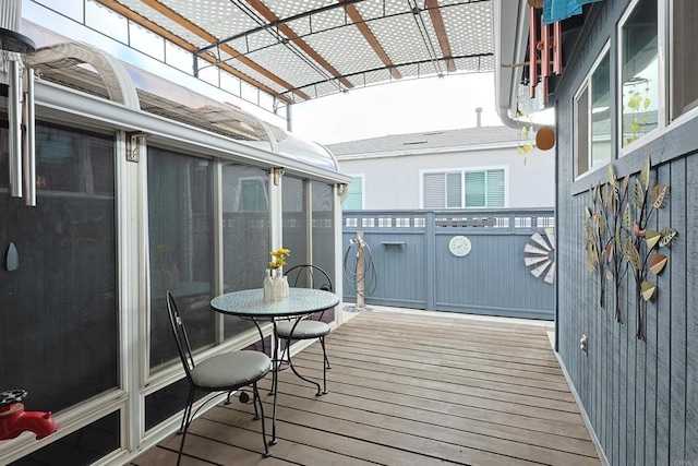 wooden deck with a sunroom