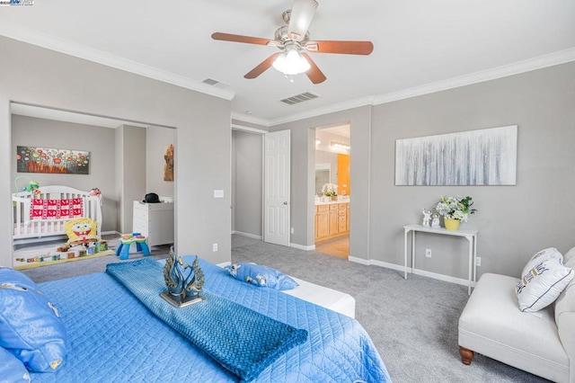 carpeted bedroom featuring ceiling fan, ornamental molding, and connected bathroom