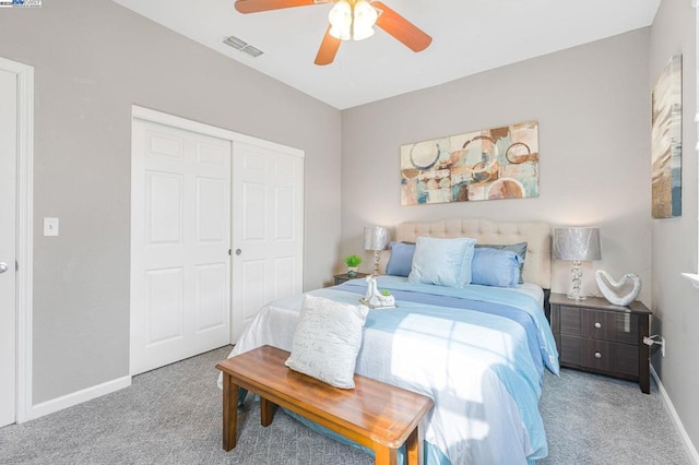 carpeted bedroom featuring ceiling fan and a closet