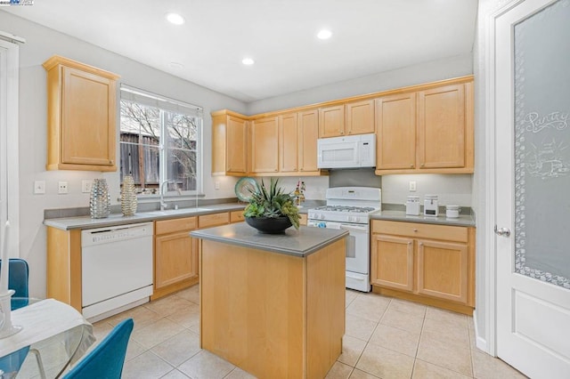 kitchen with a kitchen island, light brown cabinetry, sink, light tile patterned floors, and white appliances