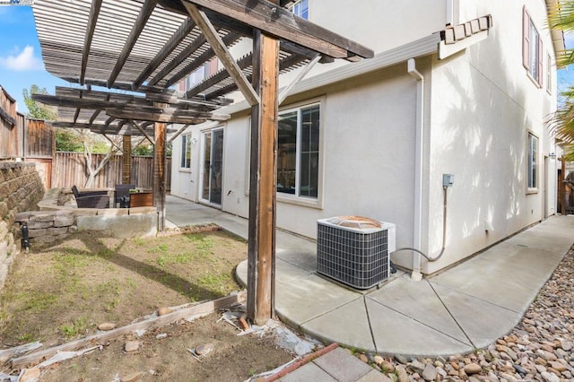 view of side of property with cooling unit, a pergola, and a patio area